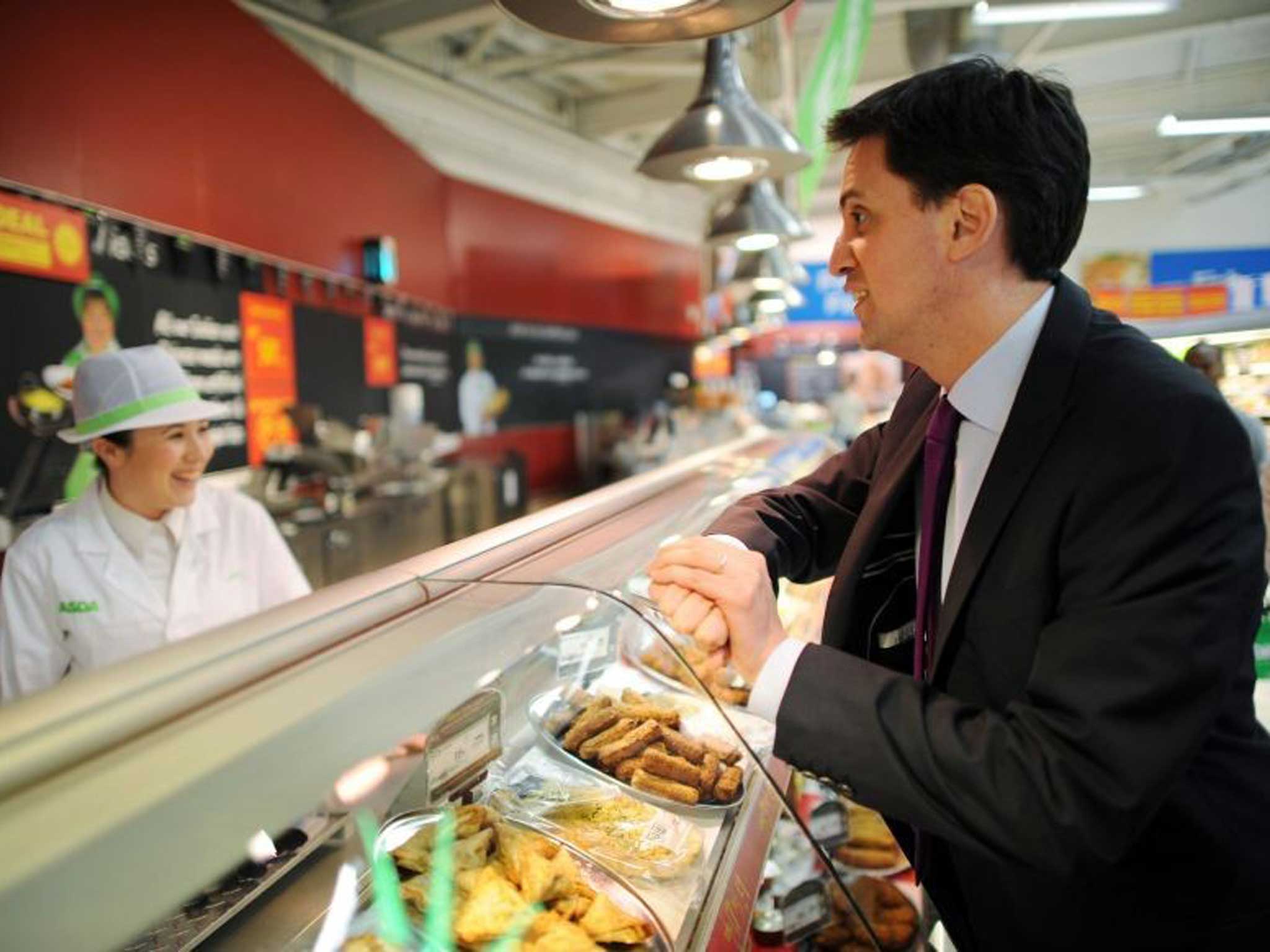 Miliband talks to a member of staff at an Asda supermarket in Harlow: the Labour leader recently admitted he didn't know the price of his own weekly shop