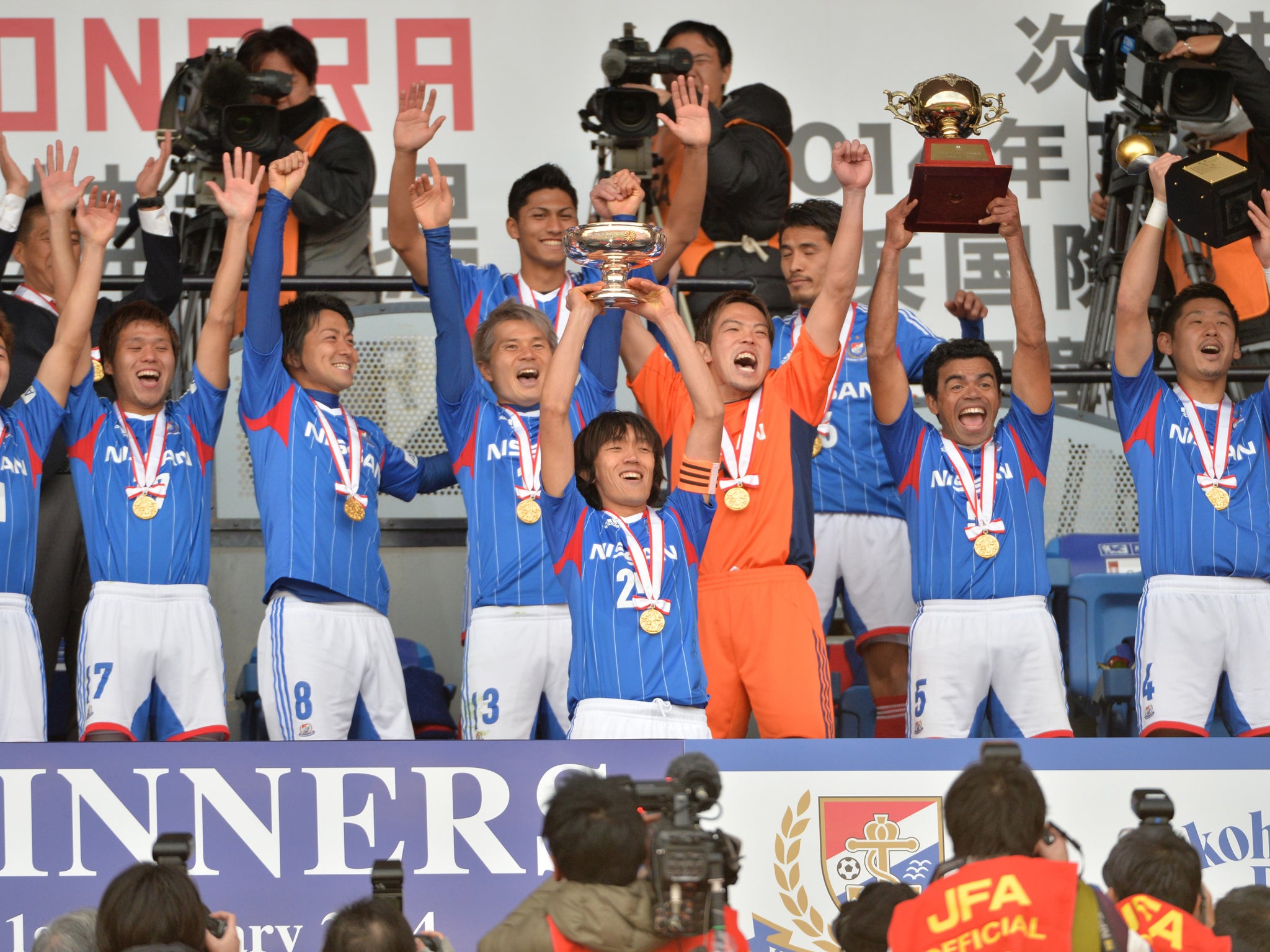 Japan's Yokohama F Marinos captain Shunsuke Nakamura (C, #25) and his teammates celebrate their victory over Sanfrecce Hiroshima during the awards ceremony of the Emperor's Cup final in Tokyo