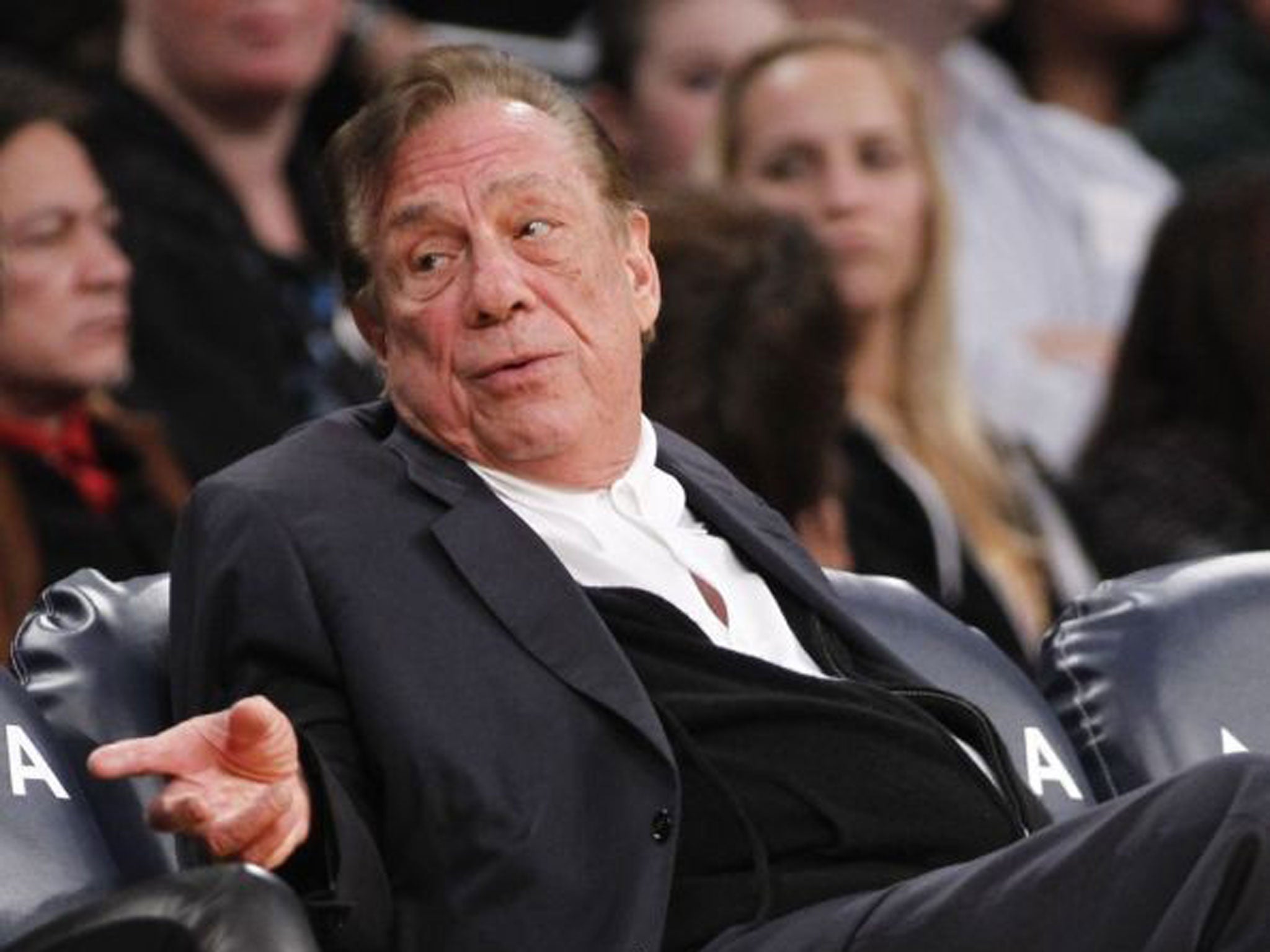 Los Angeles Clippers owner Donald Sterling gestures while watching the Clippers play the Los Angeles Lakers during an NBA preseason basketball game