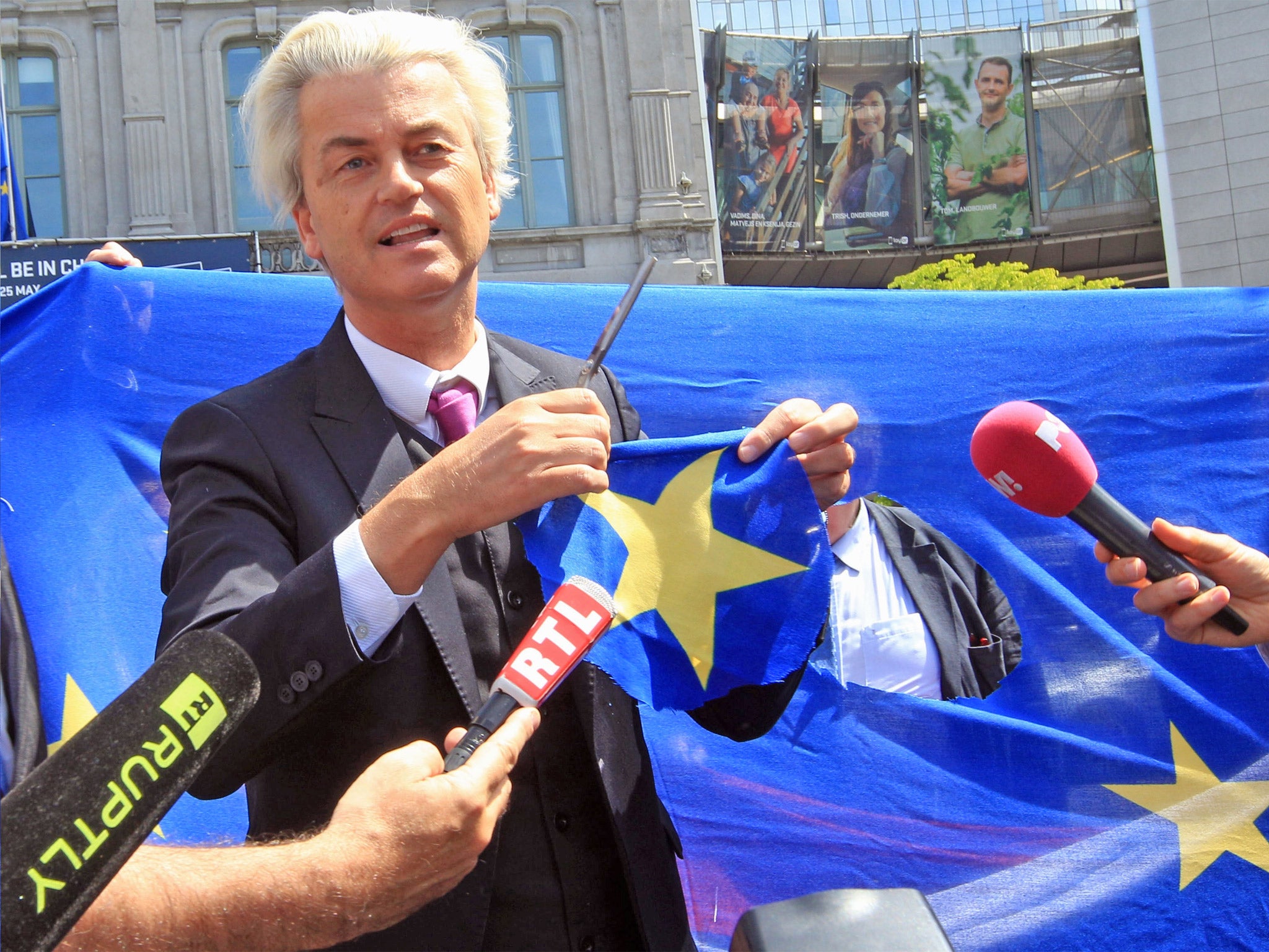 Dutch PPV party leader Geert Wilders displays a yellow star he cut out of the EU flag in front of the European Parliament in Brussels