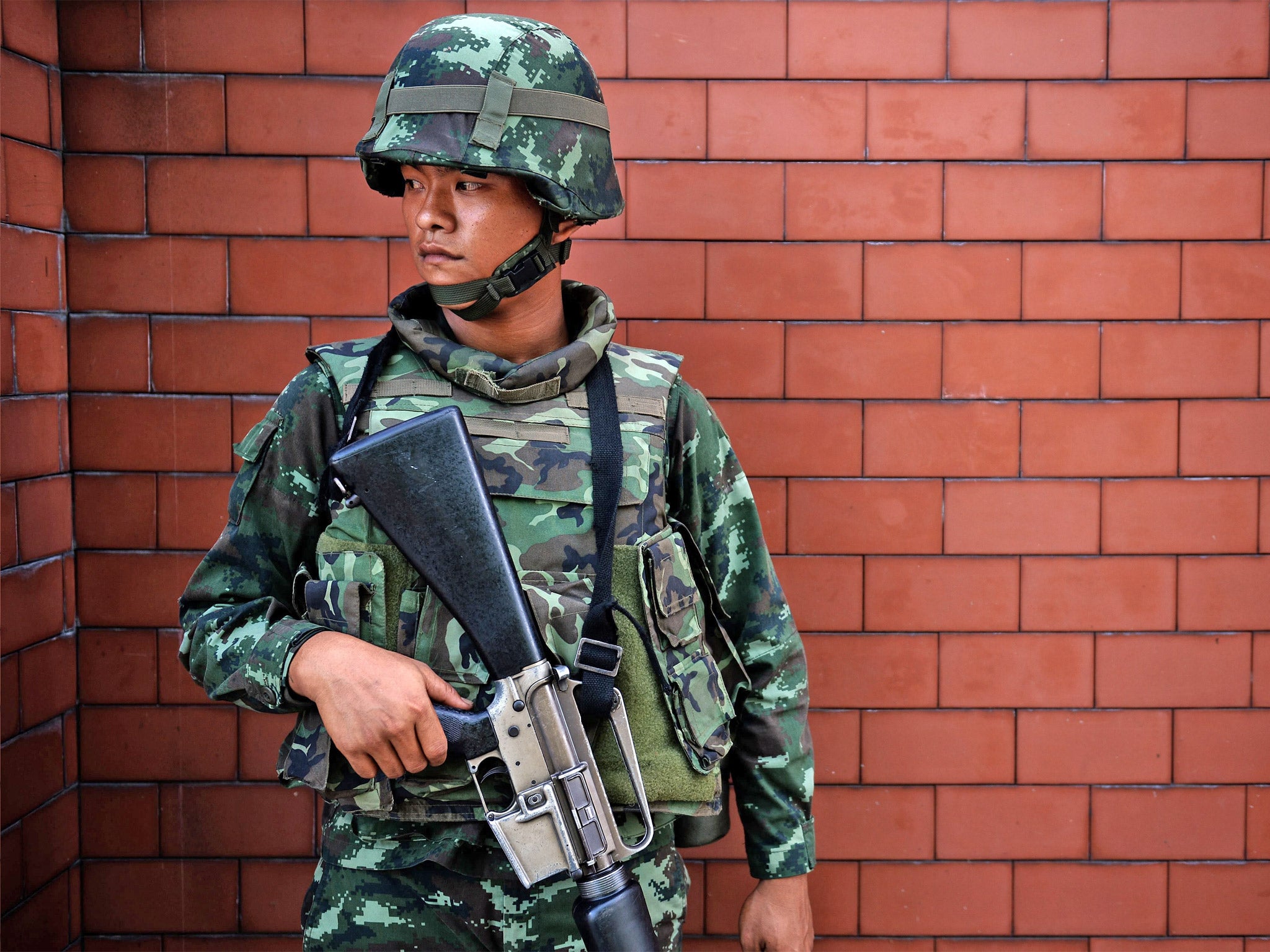 A Thai soldier stands outside the Government Public Relations Department in Bangkok (Getty)