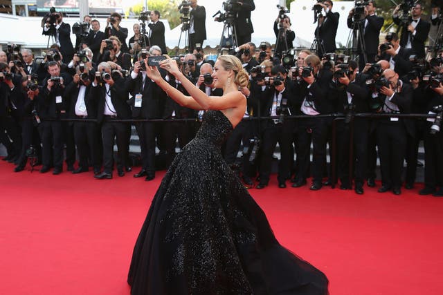 Model Petra Nemcova can’t resist taking a selfie on the Cannes red carpet.
