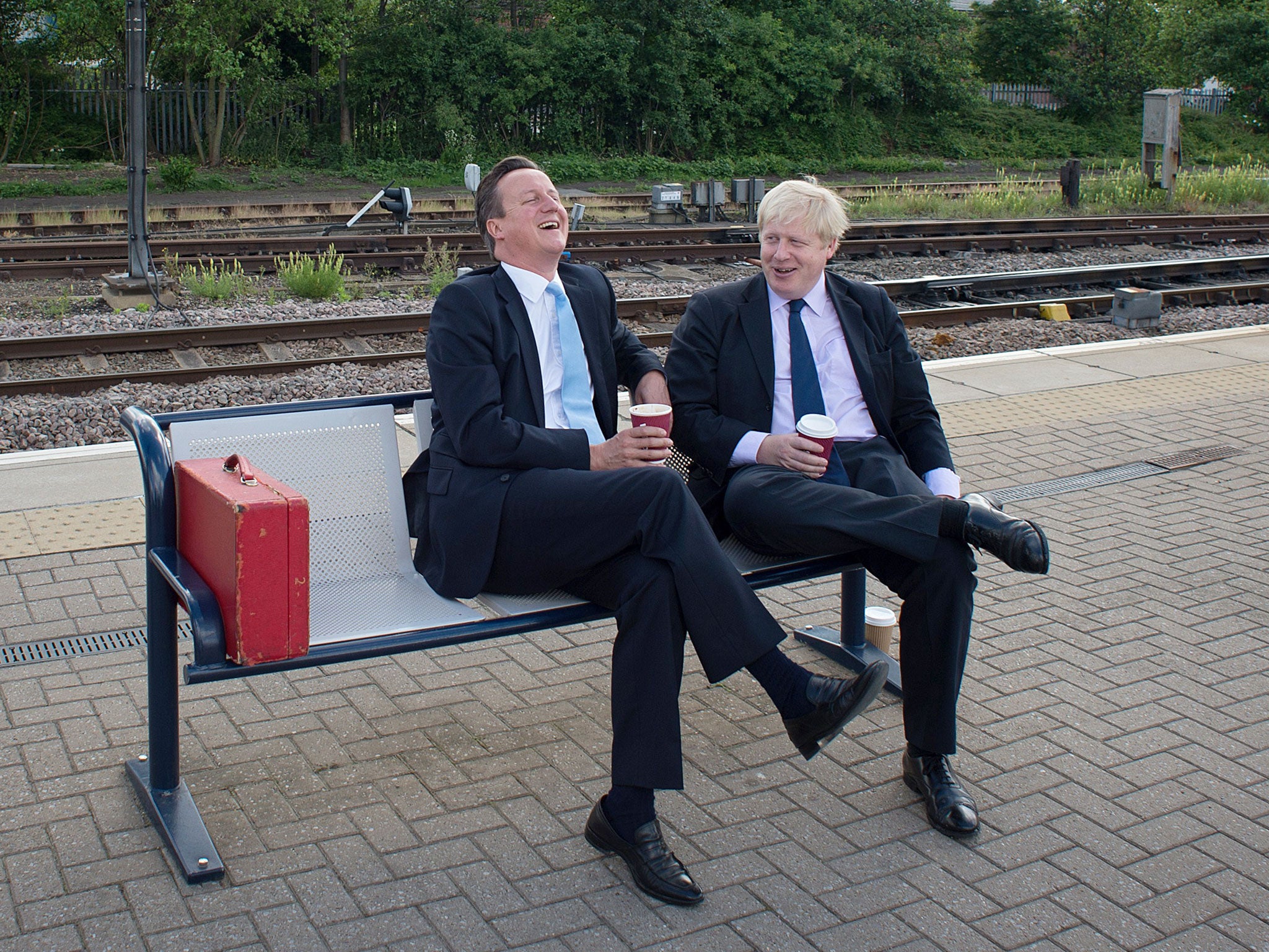 British Prime Minister Prime Minister David Cameron (L) and Mayor of London Boris Johnson wait for a train at Newark station in central England, following a visit to the town were they campaigned ahead of the Newark by-election