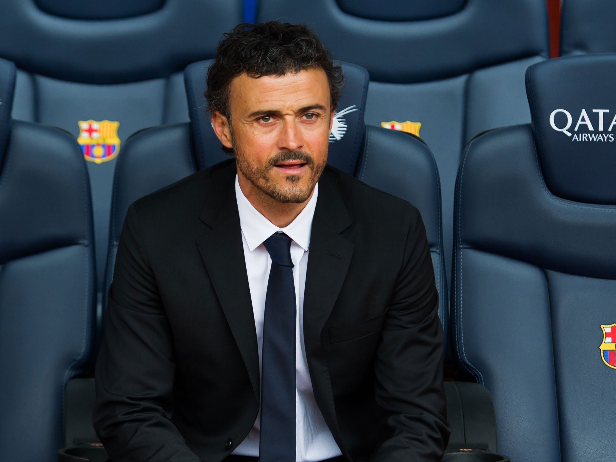 Newly appointed Barcelona manager Luis Enrique tries out his seat at the Nou Camp today