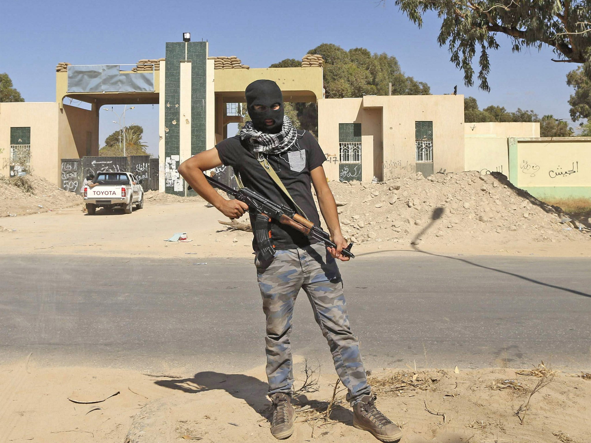 A militiaman guards his camp after clashes in Benghazi last week