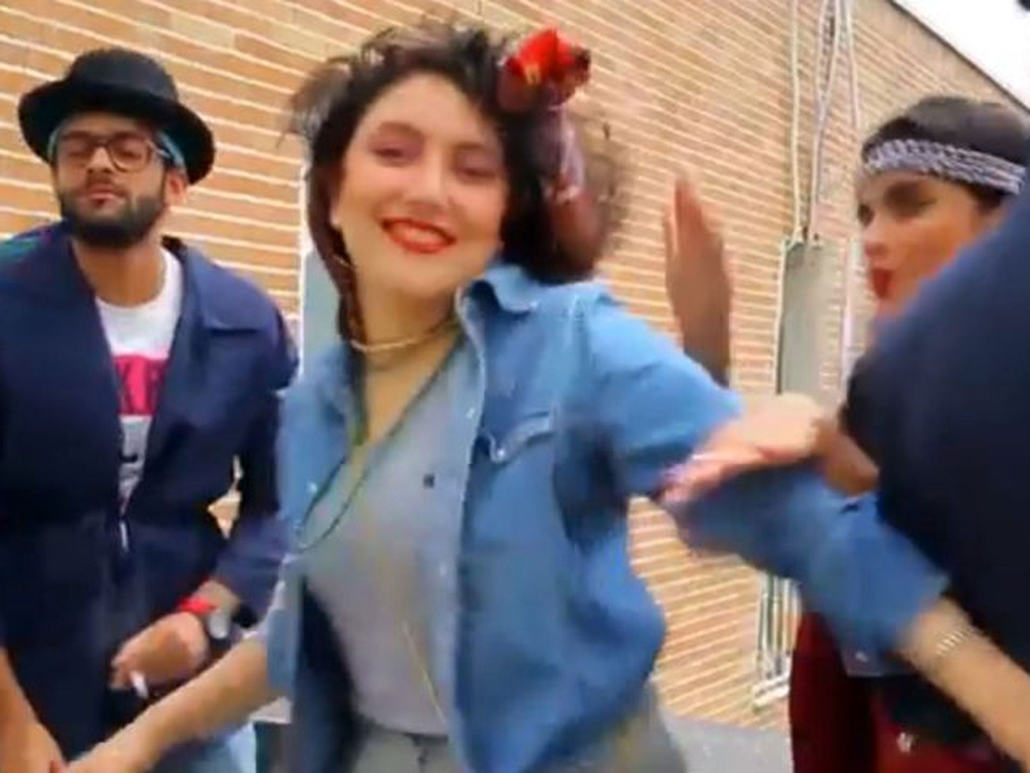 In this frame grab taken from video posted to YouTube, people dance to Pharrell Williams' hit song "Happy" on a rooftop in Tehran, Iran.