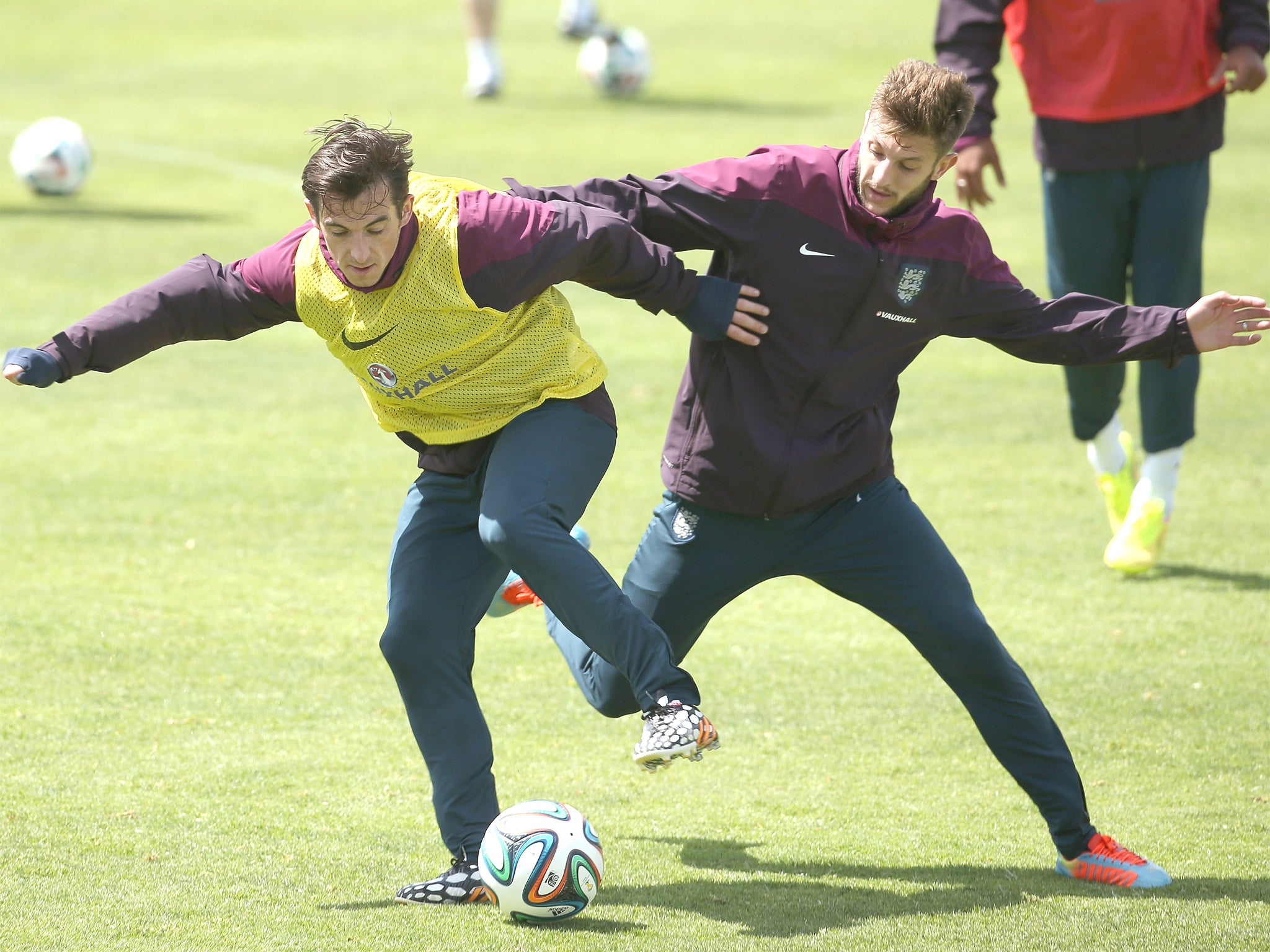 Leighton Baines and Adam Lallana tussle for the ball during training at the Vale Do Lobo Resort