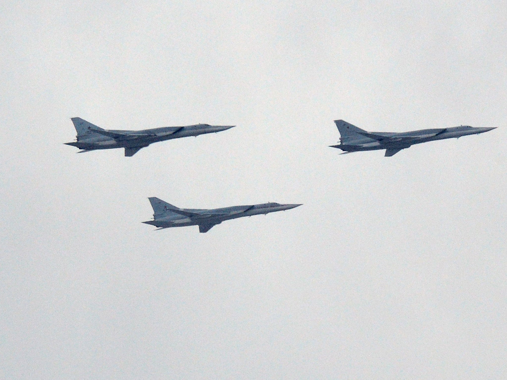Russian Tupolev Tu-22M supersonic strategic bombers fly above the Kremlin's cathedrals in Moscow, on May 7, 2014, during a rehearsal of the Victory Day parade