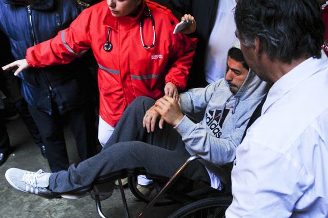 Luis Suarez leaves hospital after having surgery on his injured meniscus in his right knee