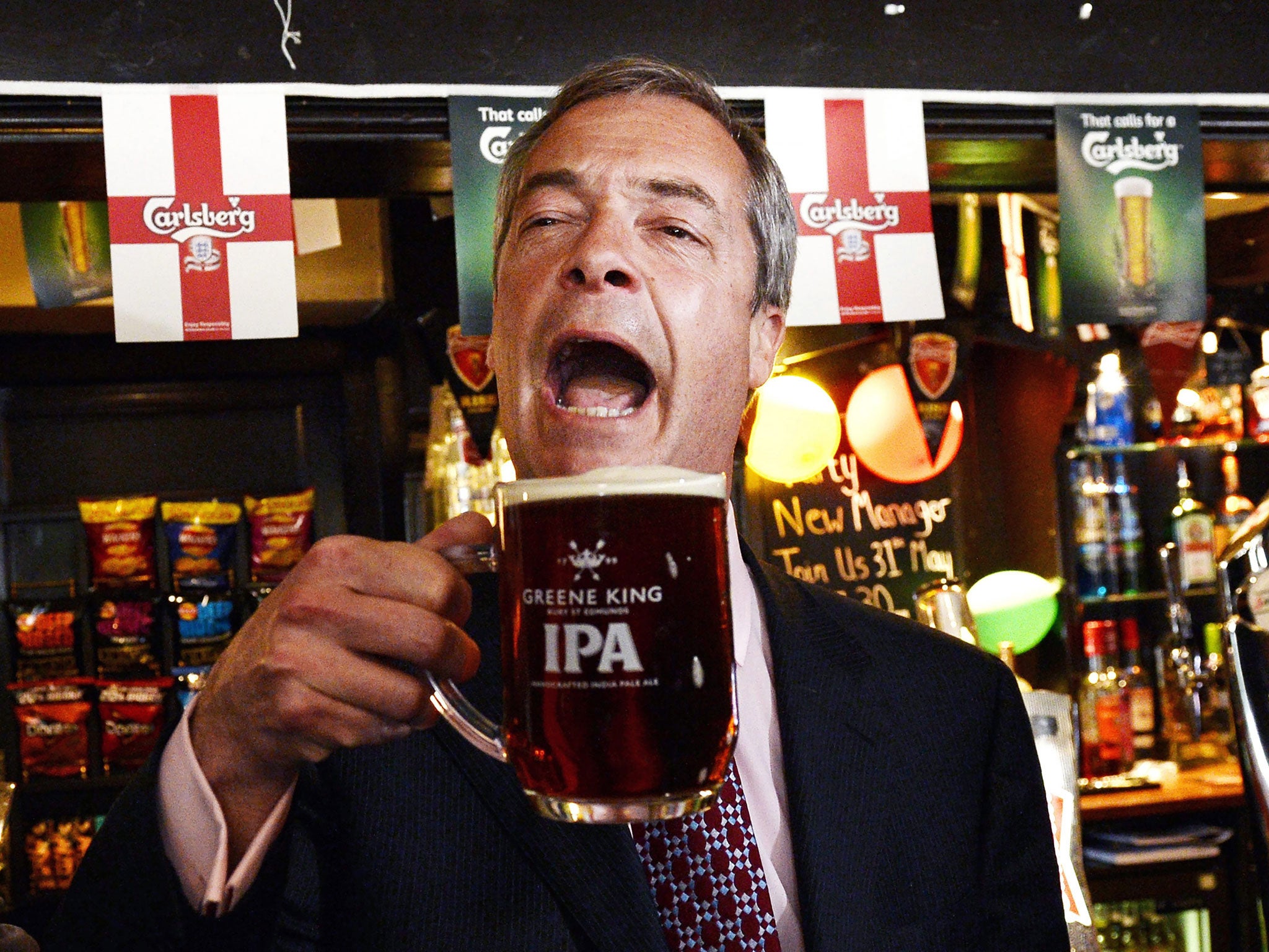 Nigel Farage celebrates with a pint after early local election results in the Hoy and Helmet pub in South Benfleet in Essex