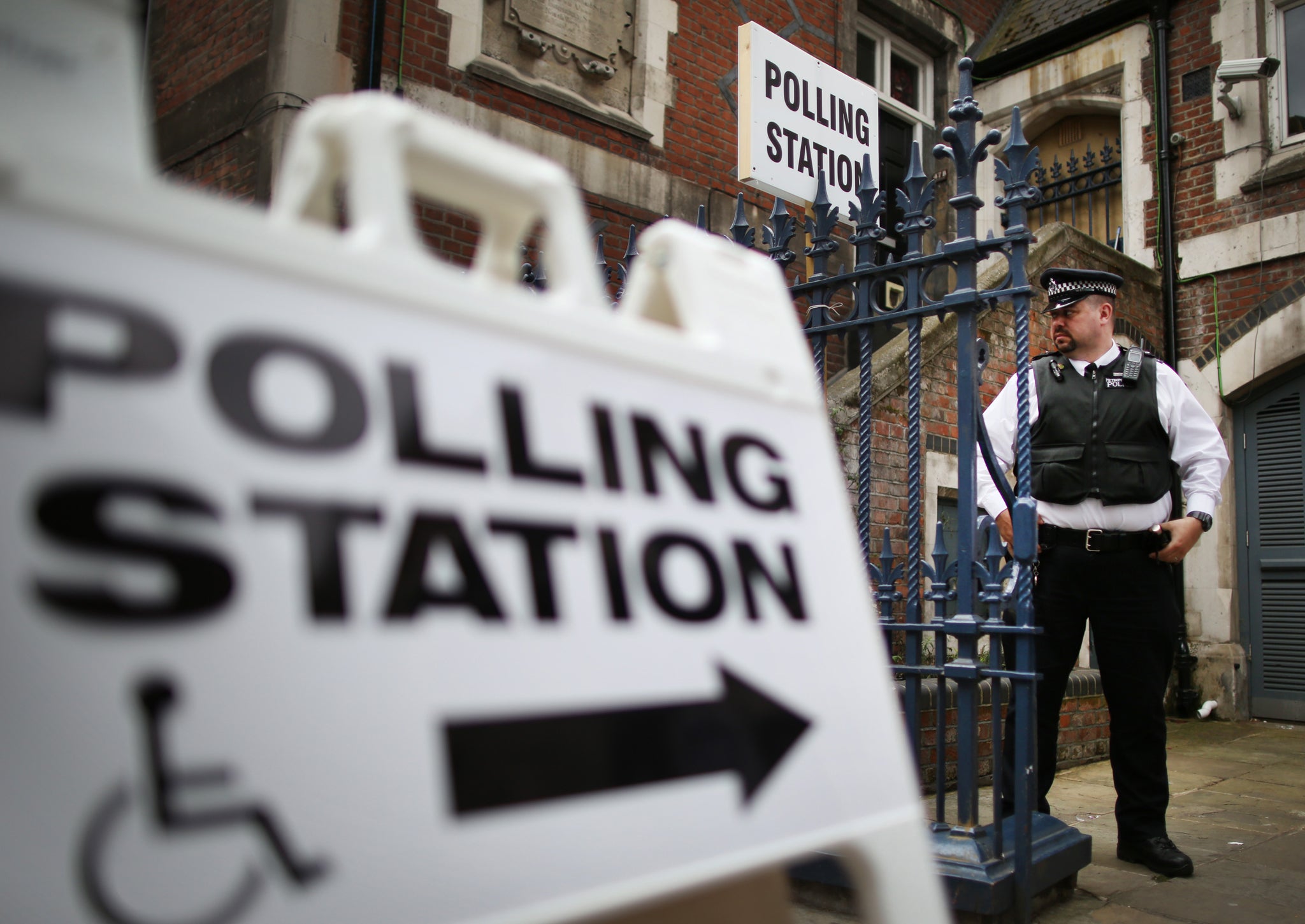 A police officer stands outside a polling station