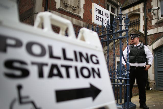 A police officer stands outside a polling station