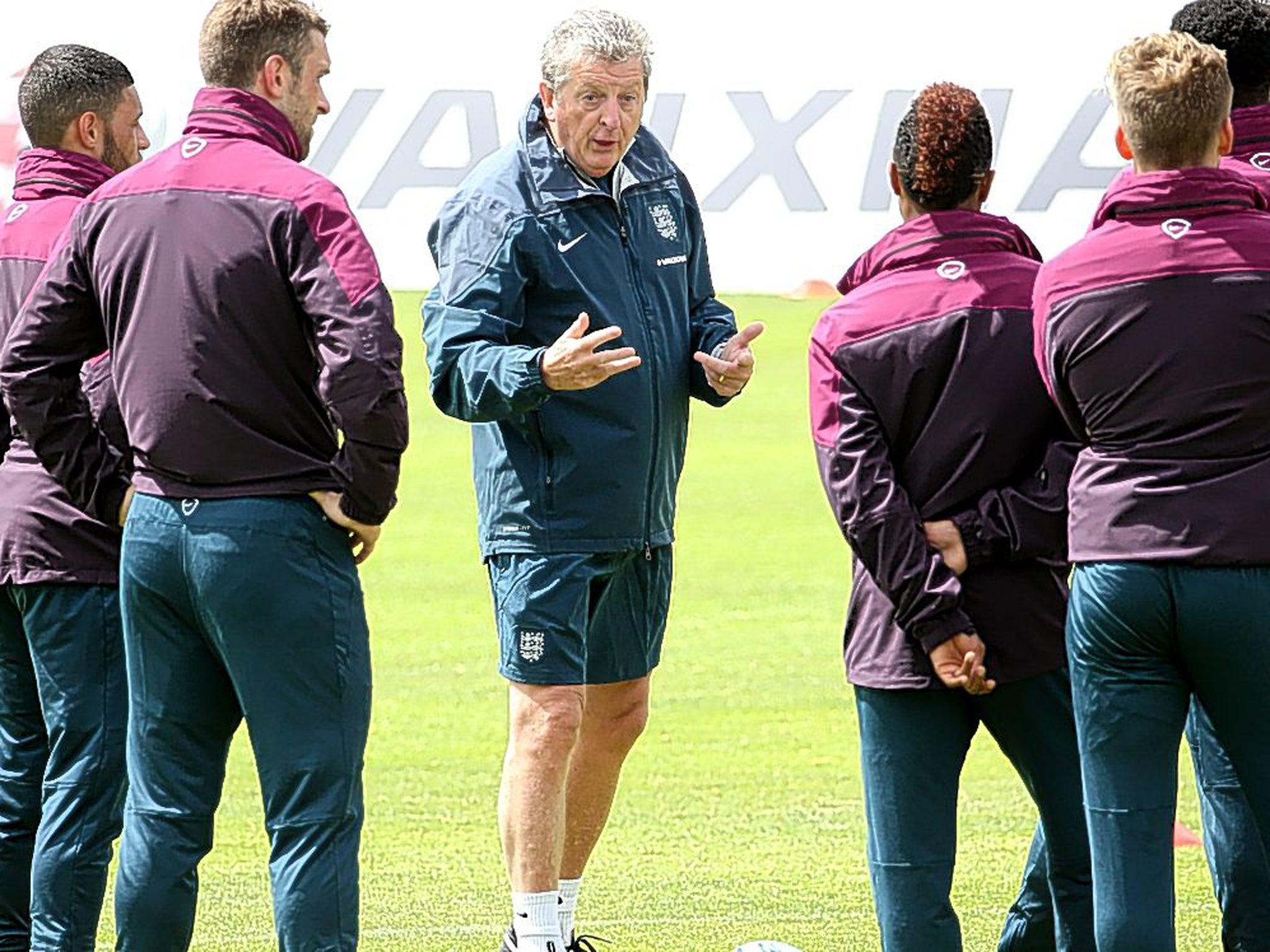 Vying for attention: England’s World Cup hopefuls surround manager Roy Hodgson in Portugal last week