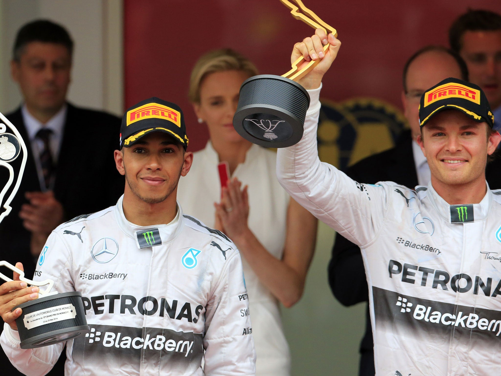 Mercedes' German driver Nico Rosberg (right) holds his trophy next to team-mate Lewis Hamilton (left) on the podium. The pair barely acknowledged each other after the race