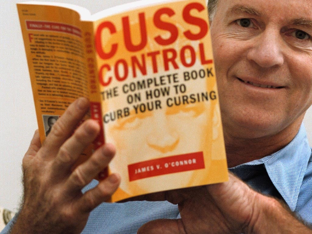 James V. O''Connor, author and president of the Cuss Control Academy displays his book 'Cuss Control, The Complete Book On How To Curb Your Cursing' Sept. 6, 2000