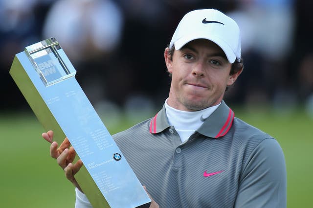 Rory McIlroy poses with the trophy 