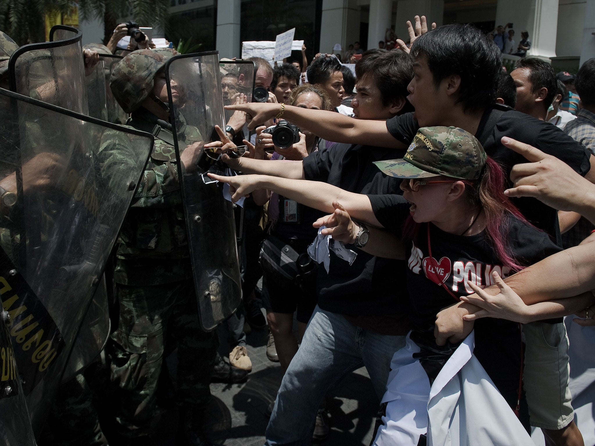Soldiers scuffle with protesters at a rally in Bangkok