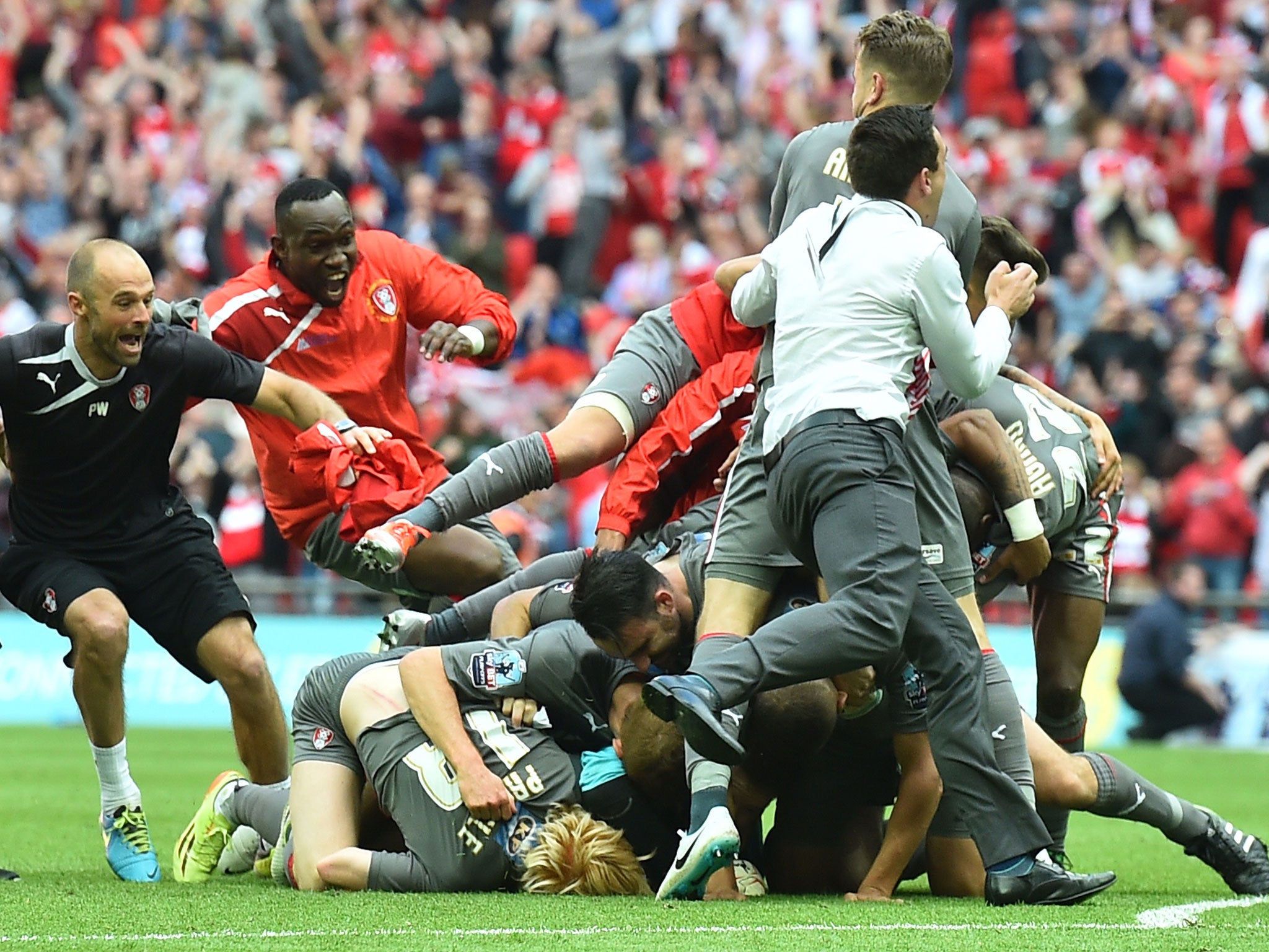 Rotherham United players and staff celebrate after winning Sunday’s League One play-off final against Leyton Orient following a penalty shoot-out at Wembley
