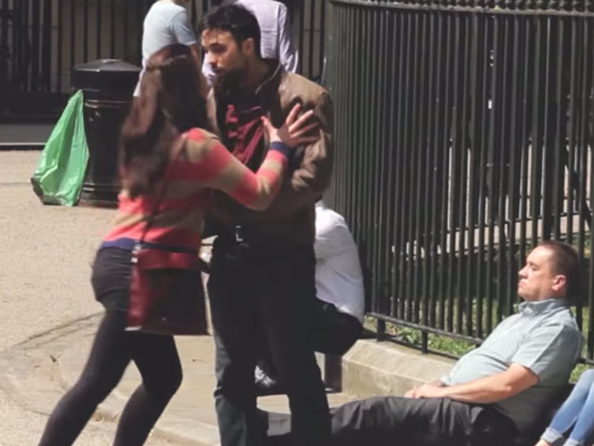 A female attacker pushes her victim against park railings