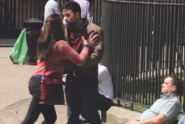 A female attacker pushes her victim against park railings
