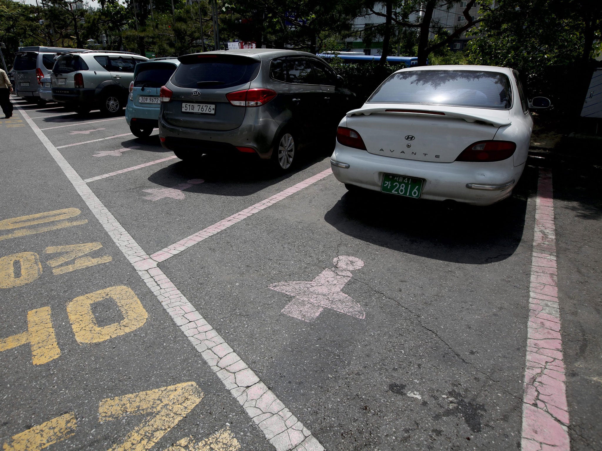 Pink outlines and a figure wearing a skirt mark the 'Women Only' parking slots at the Seodaemun office district in Seoul, South Korea