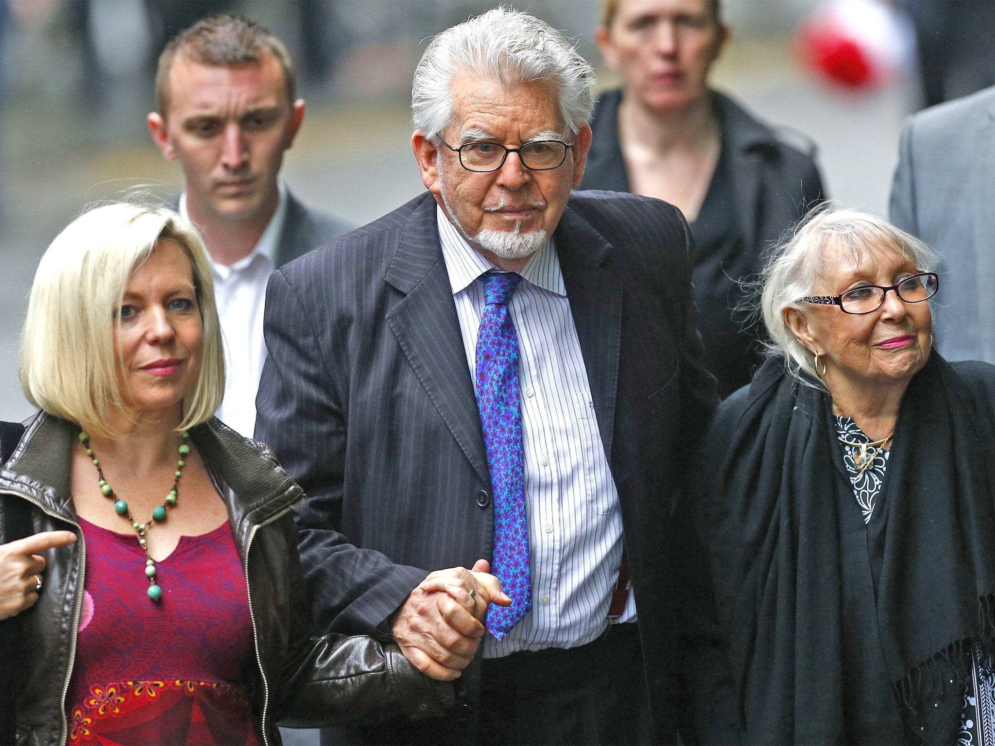 Rolf Harris arrives with his wife Alwen Hughes (right) and his daughter Bindi at Southwark Crown Court