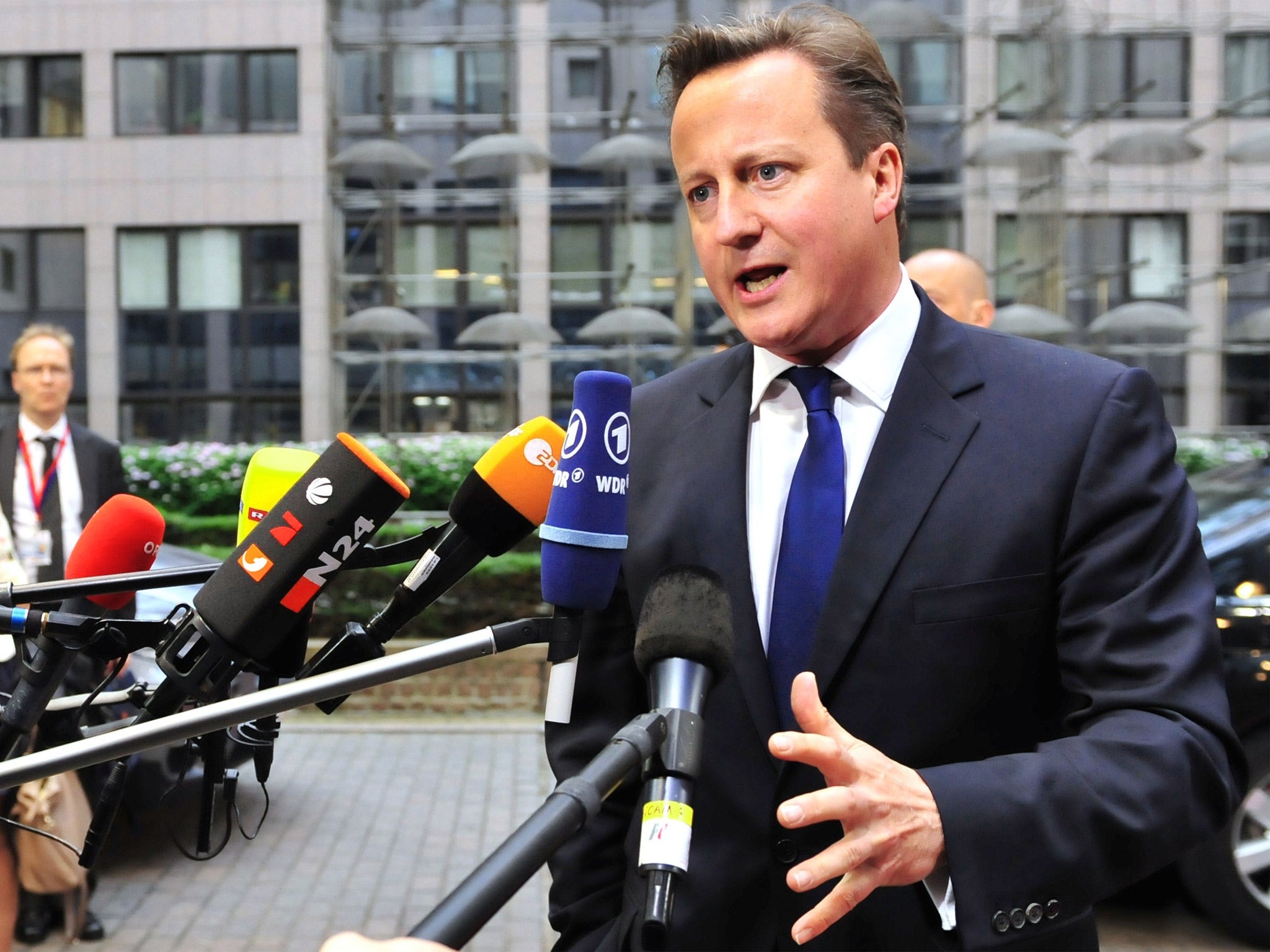 Prime Minister Cameron speaks to media as he arrives in Brussels