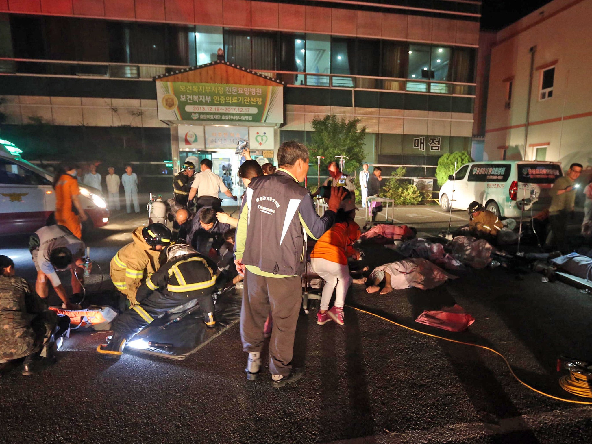 Firefighters rescue victims at a hospital in Jangseong, South Korea