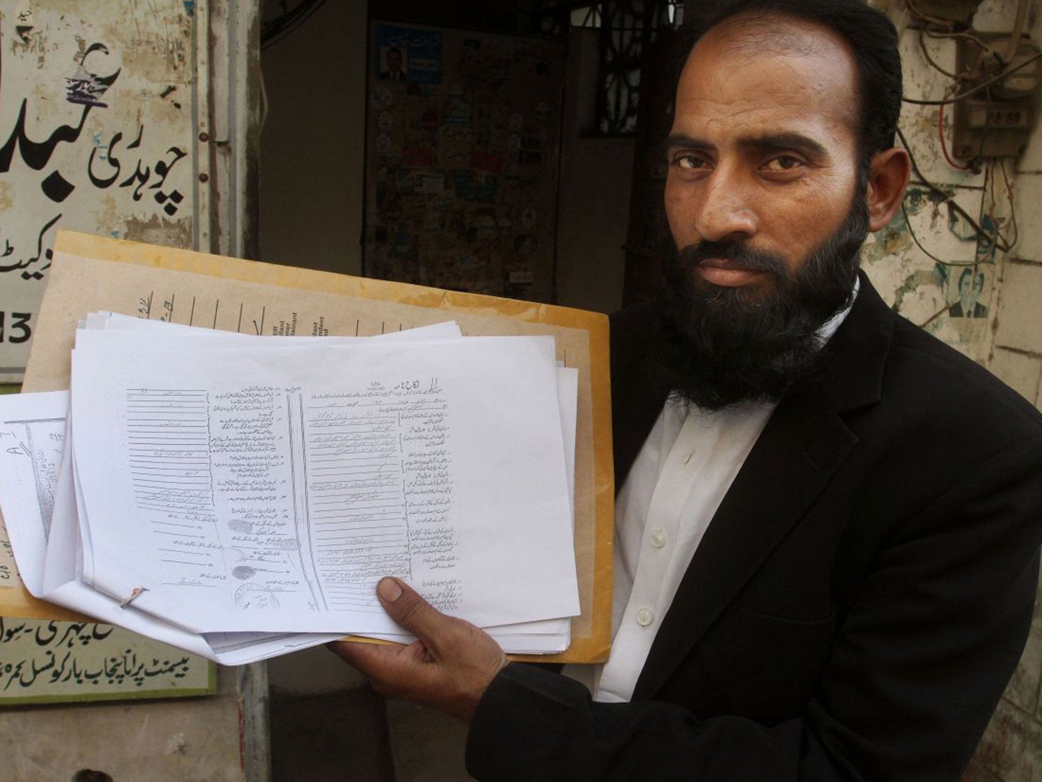 Mustafa Kharal, lawyer of pregnant woman Farzana Parveen who was stoned to death, shows her marriage certificate