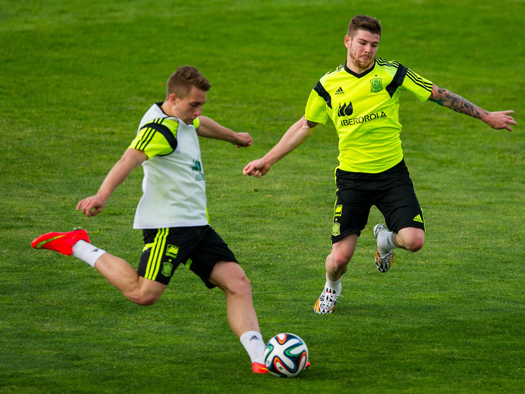 Gerard Deulofeu of Spain duels for the ball with Alberto Moreno of Spain during a training session at Ciudad del Futbol