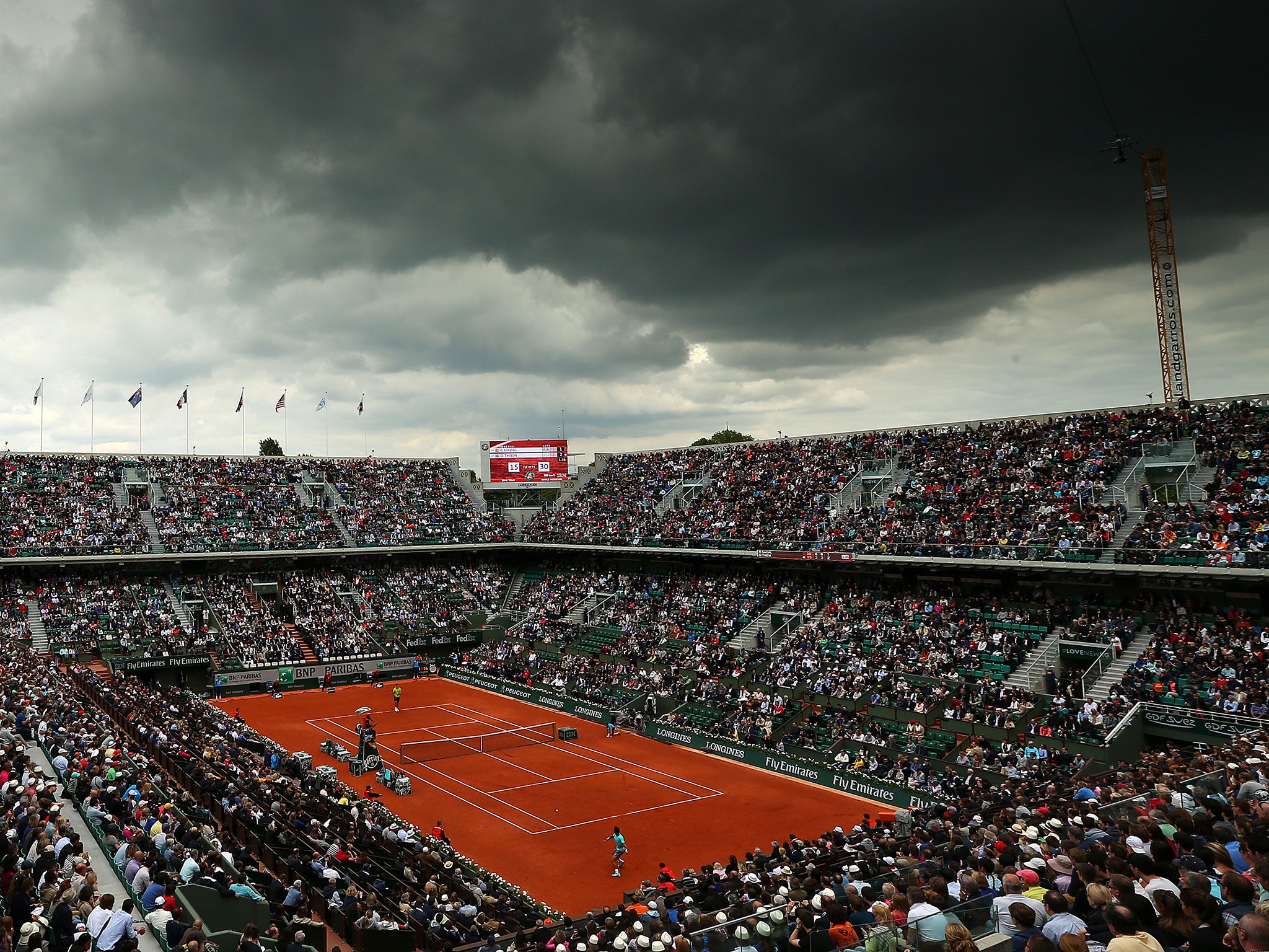 The clouds close in as Rafael Nadal of Spain secures victory in his men's singles match against Dominic Thiem of Austria