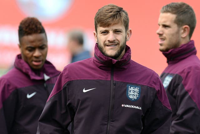 England's Adam Lallana (C), Raheem Sterling (L) and Jordan Henderson attend a training session at St George's Park training complex in Burton-on Trent, central England