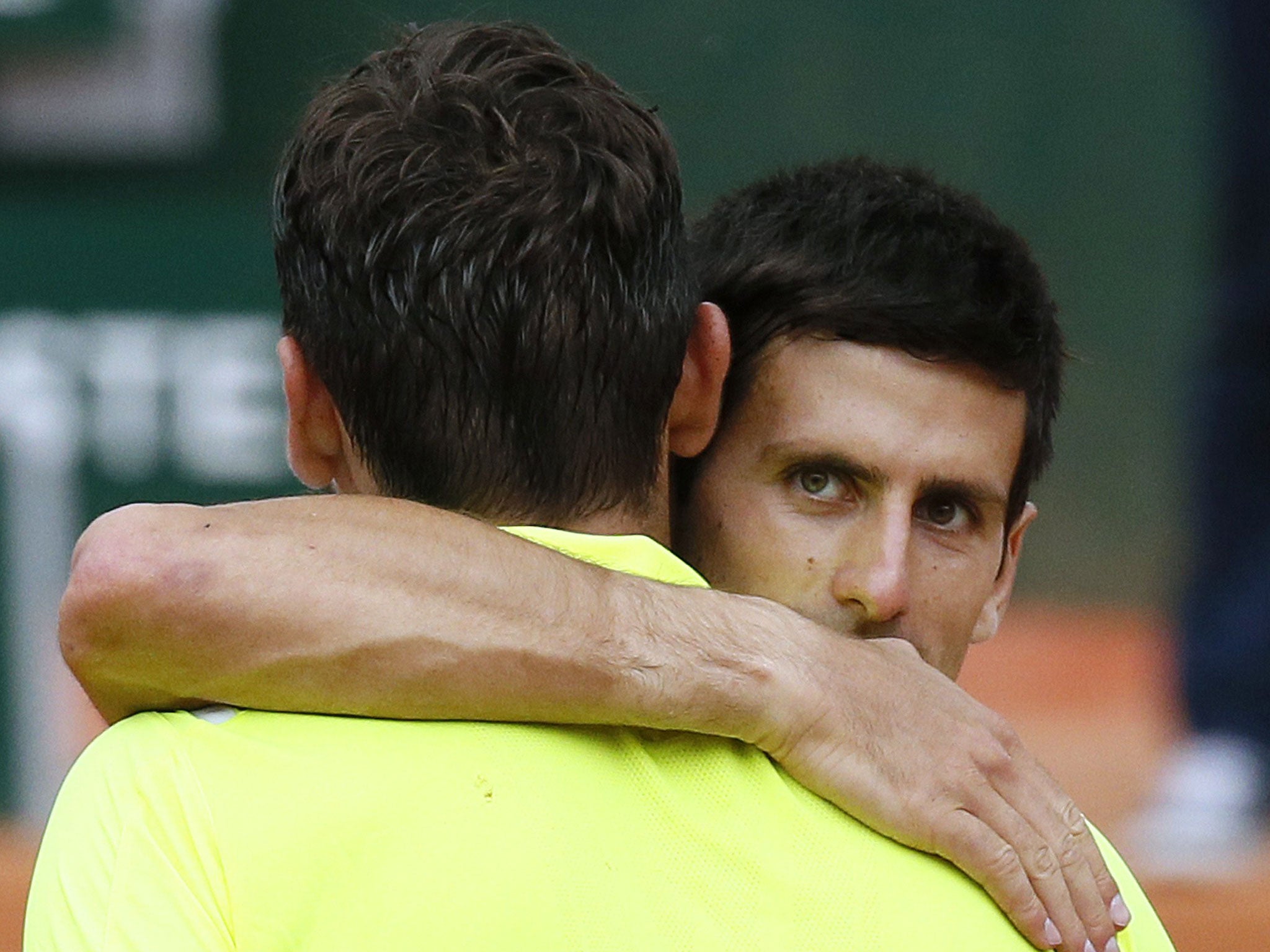 Serbia's Novak Djokovic (R) is congratulated by Croatia's Marin Cilic at the end of their French tennis Open third round match at the Roland Garros