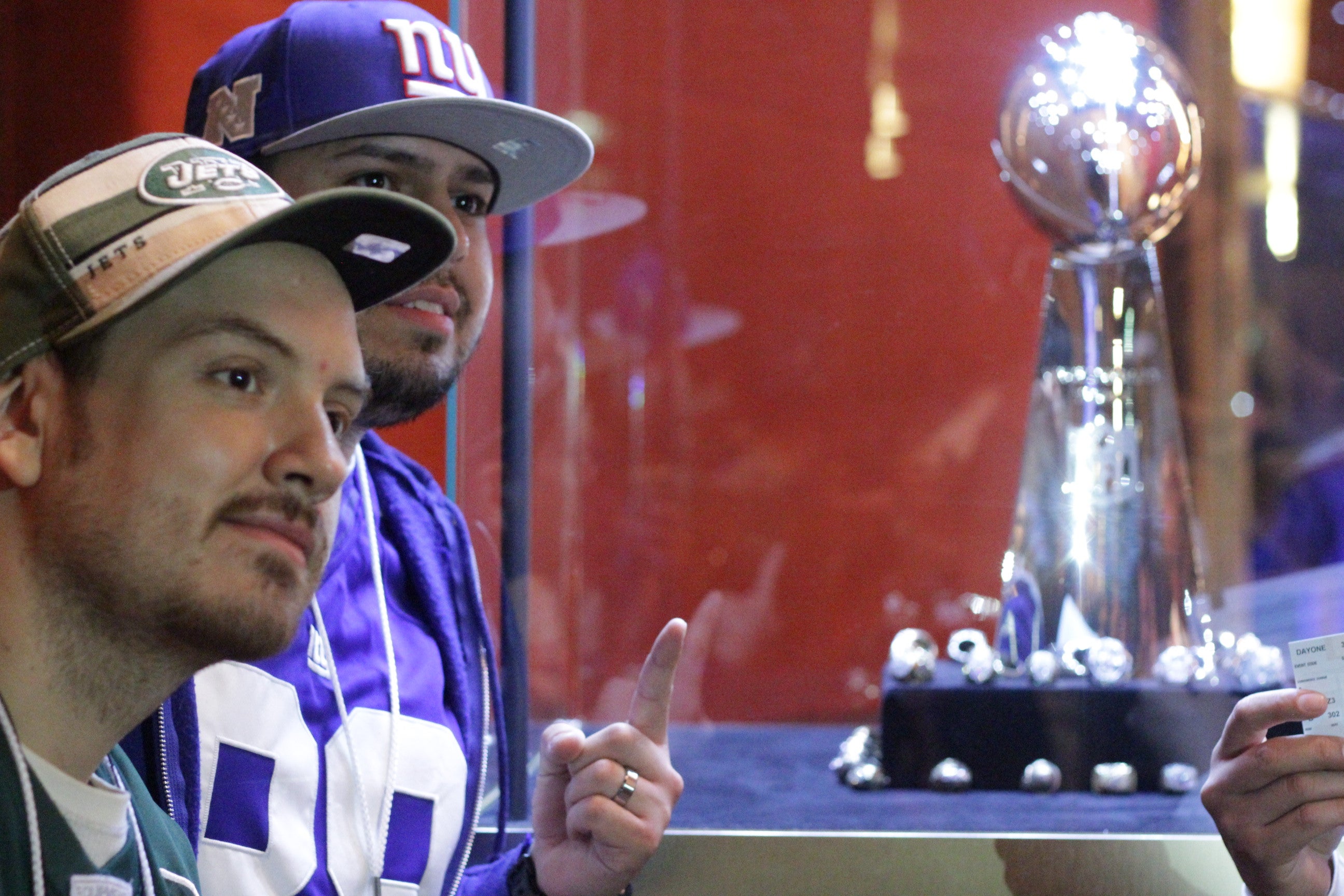 Fans pose with the Vince Lombardi trophy