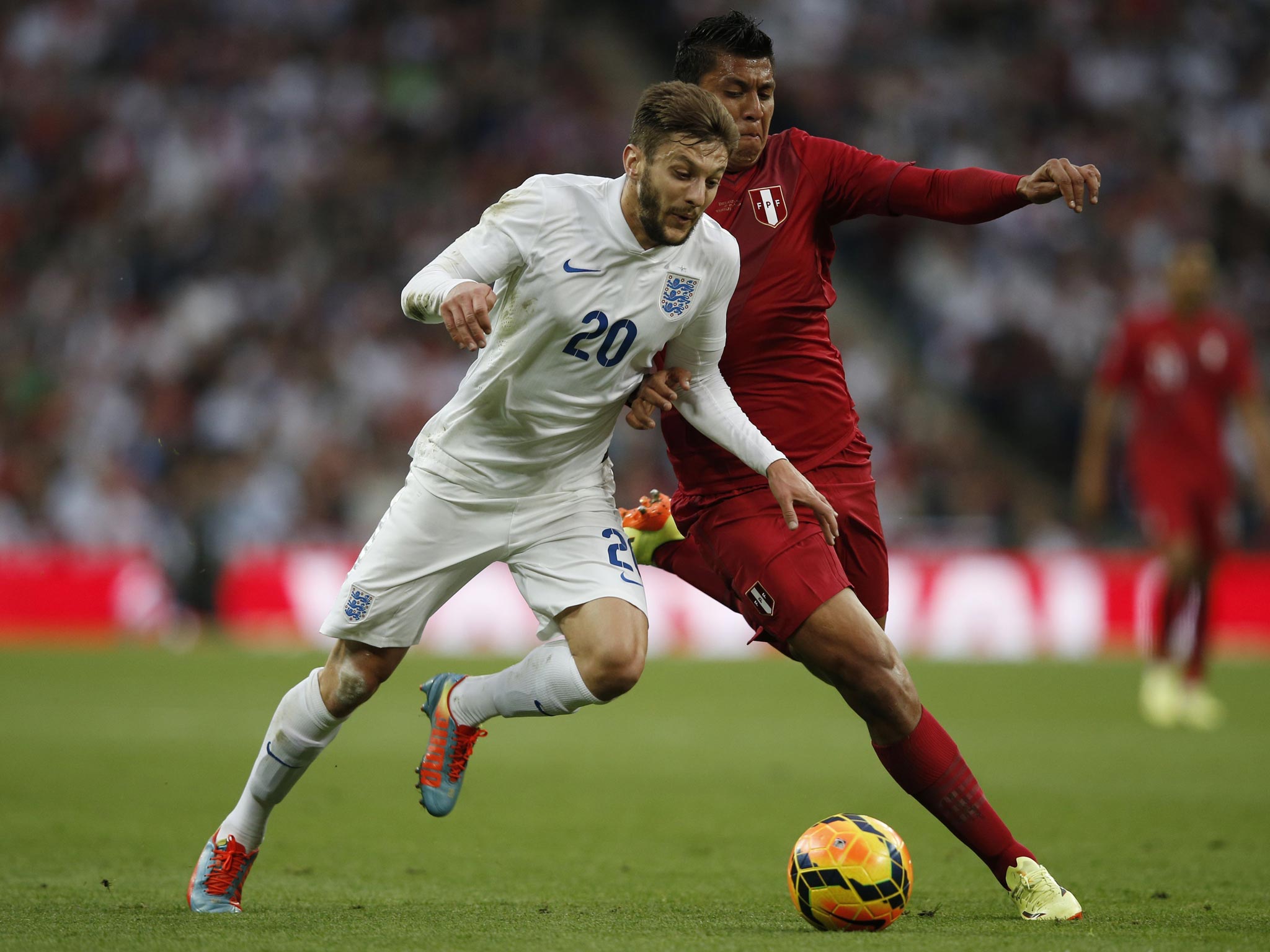England's midfielder Adam Lallana (L) bursts into the box tracked by Peru's midfielder Rinaldo Cruzado
