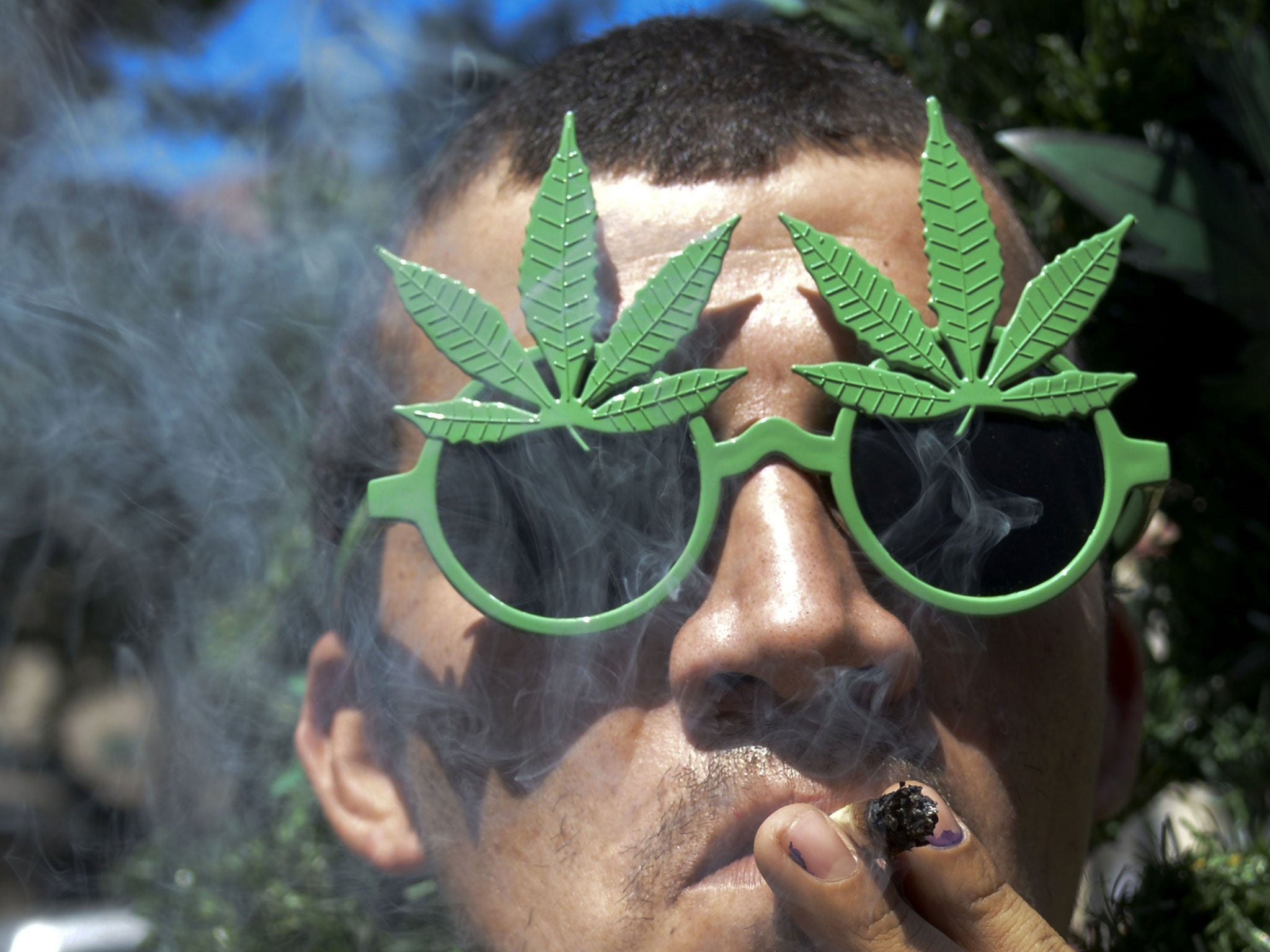 A man smokes marijuana during the World Day for the Legalization of Marijuana in Medellin, Antioquia department, Colombia on May 3, 2014.