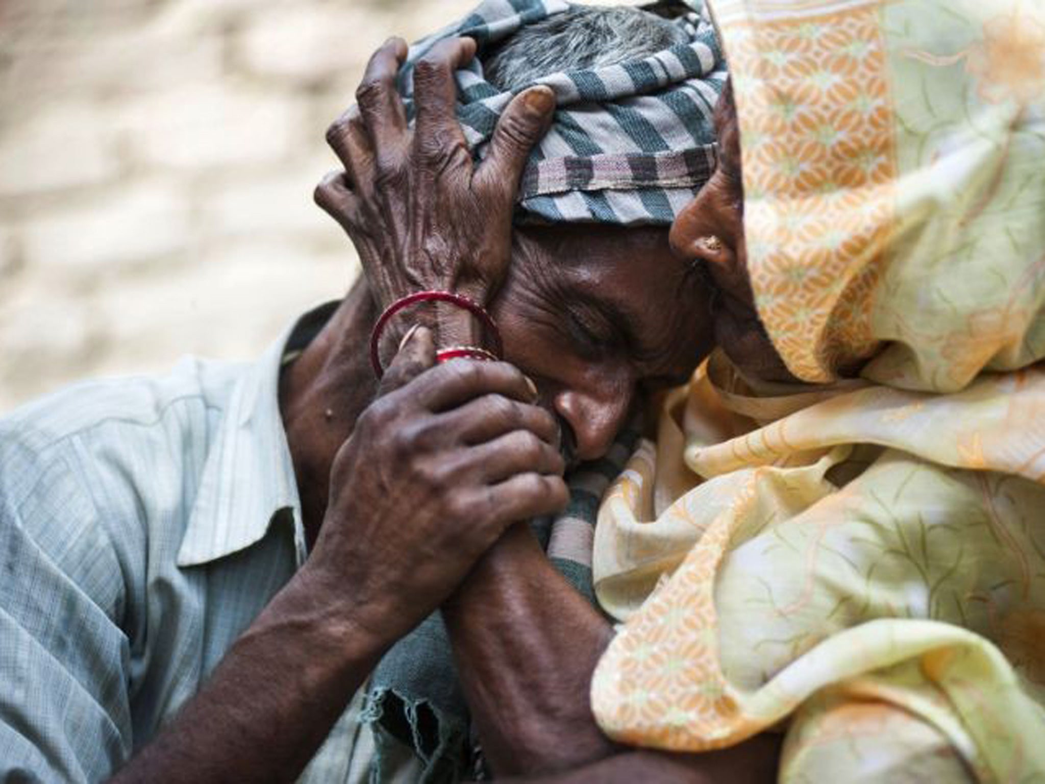 Sohan Lal, father and uncle of Murti and Pushpa, the two girls who were raped and hanged in Katra Sadatganj in Uttar Pradesh, is comforted by his mother 