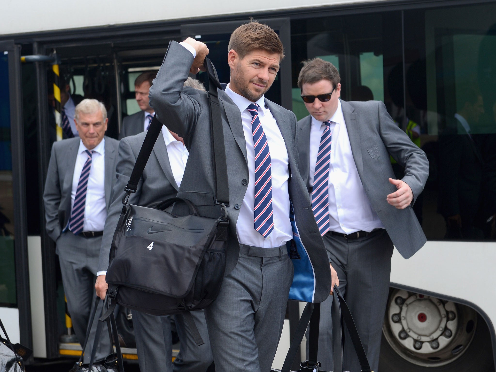 Steven Gerrard prepares to board the plane