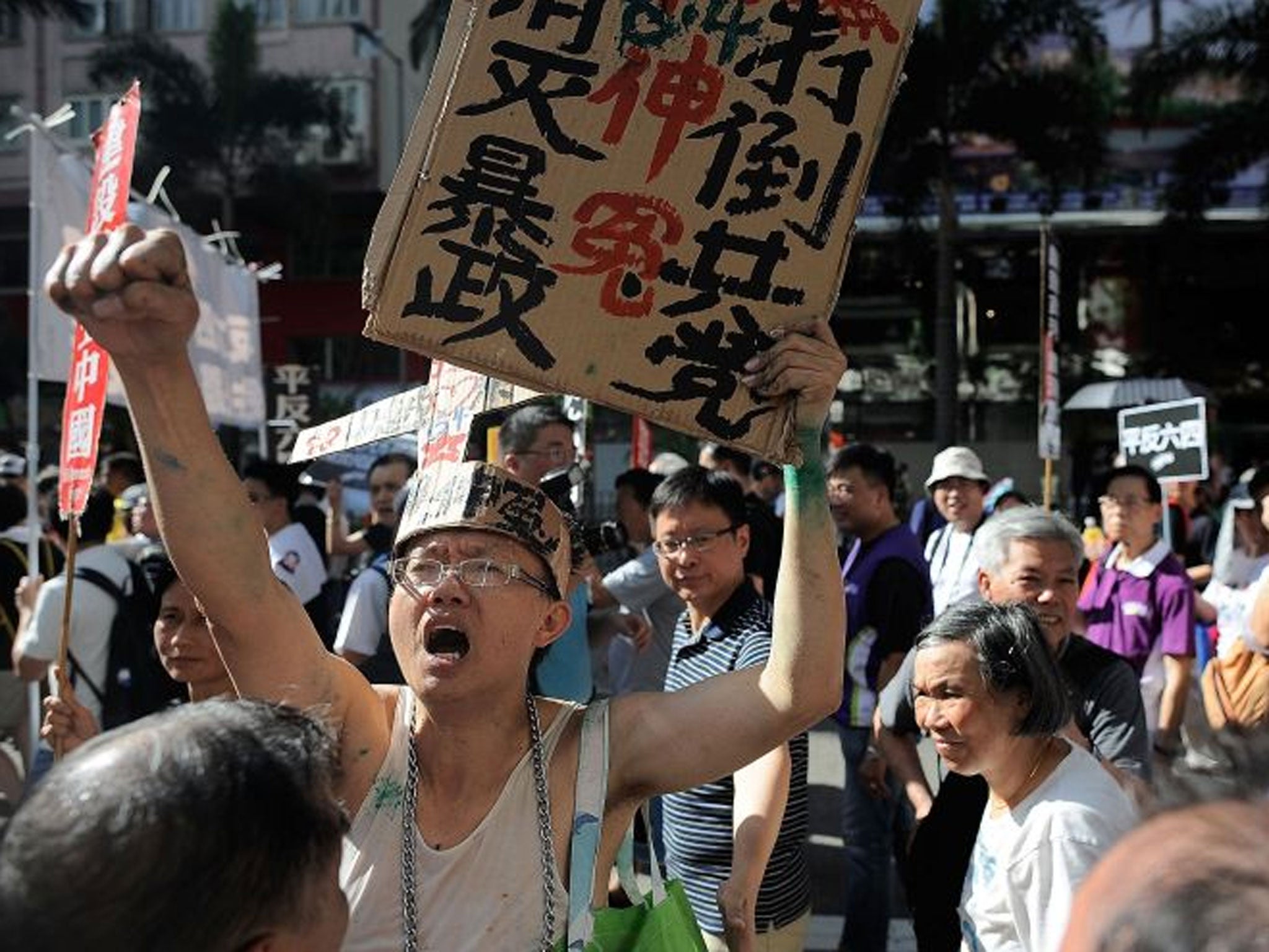 Pro-democracy activists shout slogans as they march on a street during a rally
