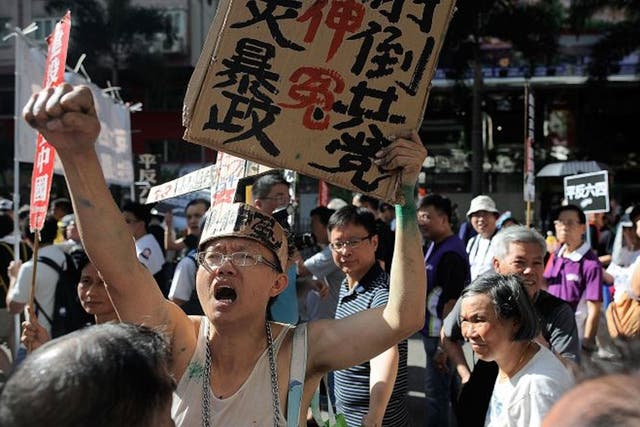 Pro-democracy activists shout slogans as they march on a street during a rally