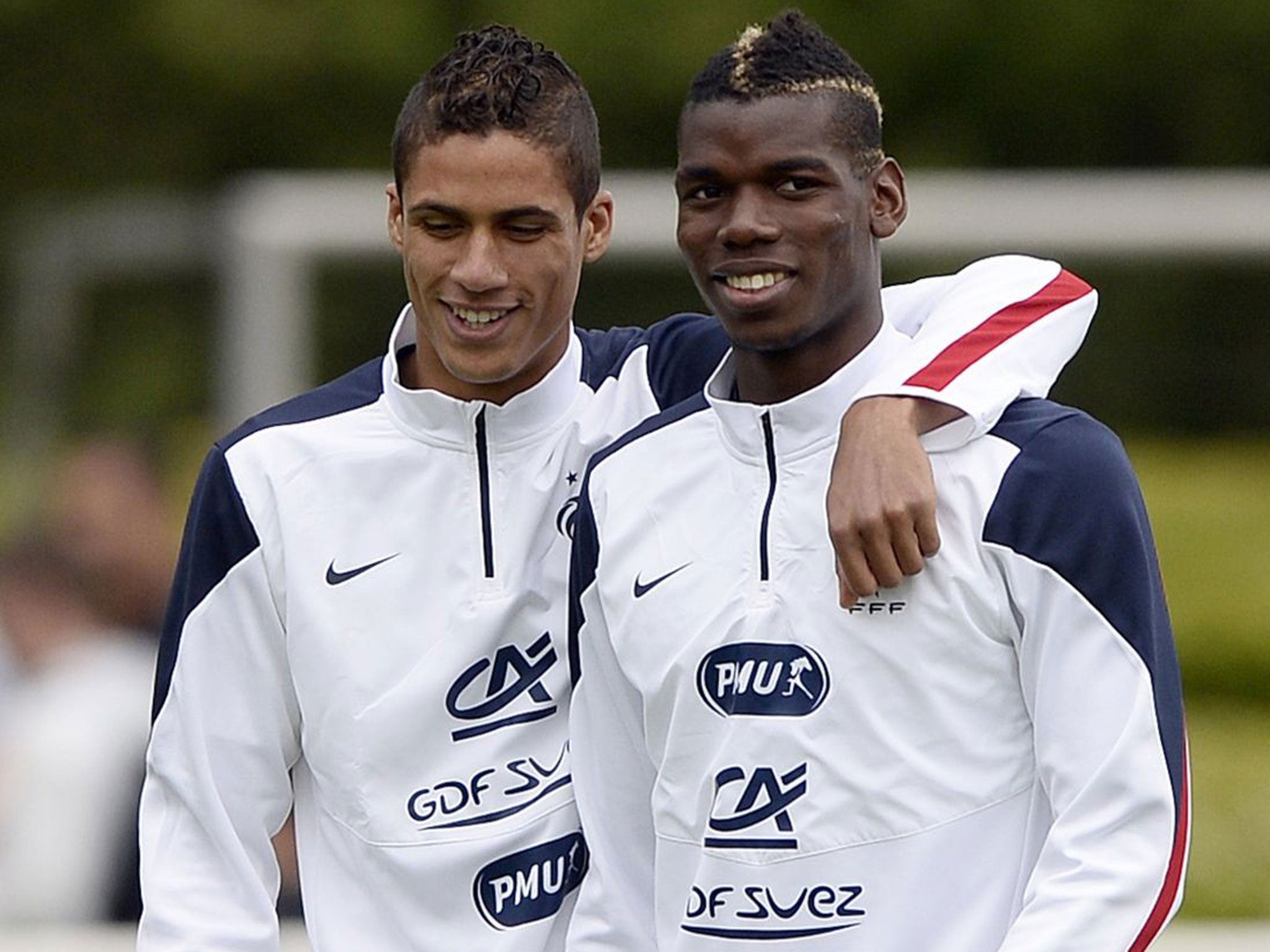 Raphaël Varane (left) jokes with Paul Pogba during a France training session last week