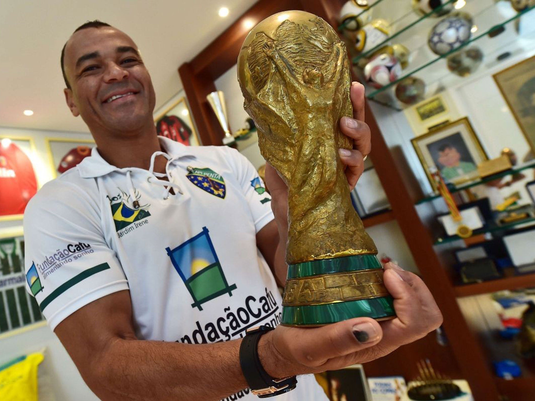 Cafu poses with the replica of the World Cup trophy he had made after leading Brazil to victory in the 2002 tournament in Japan and South Korea