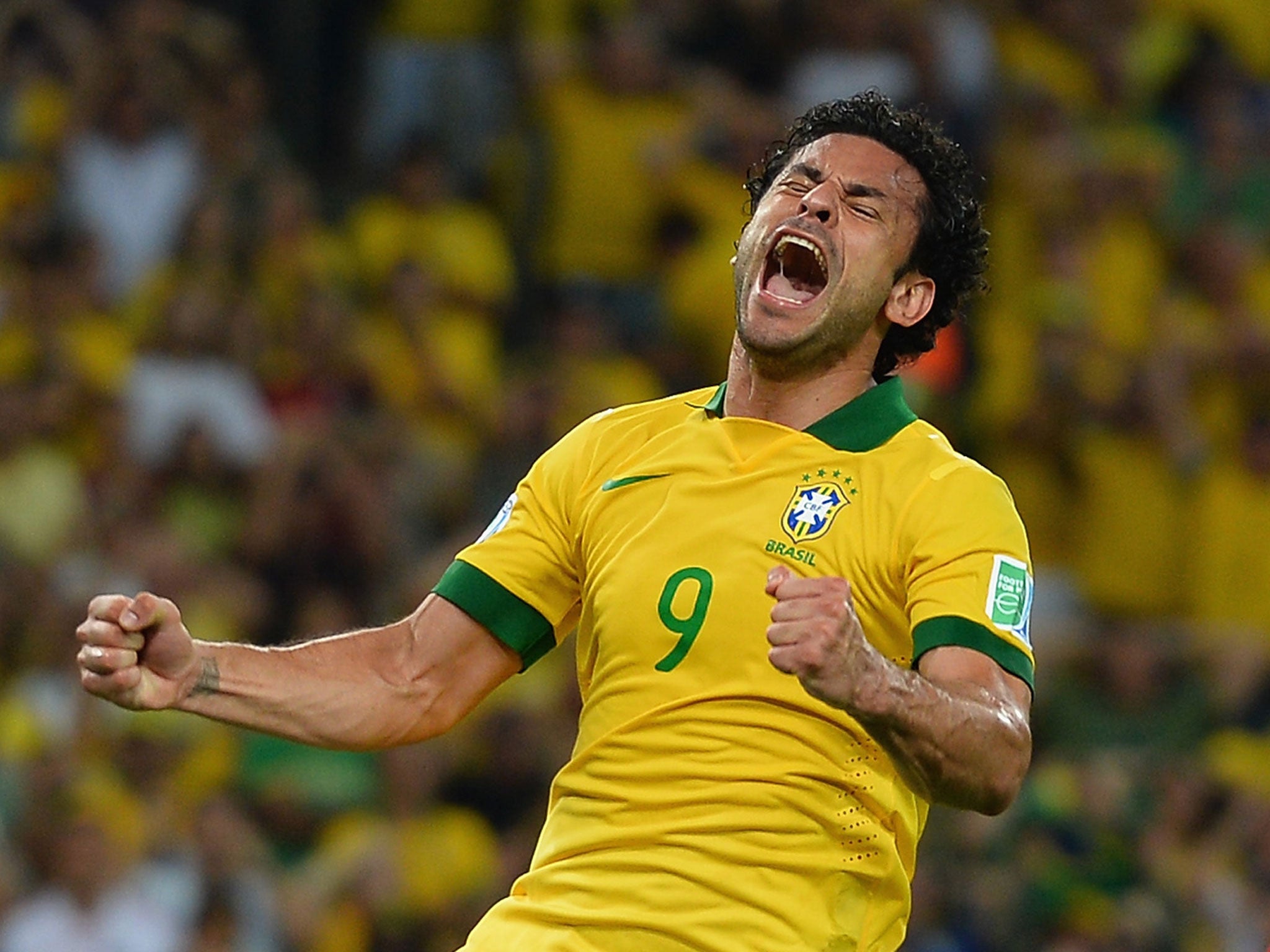 Fred celebrates scoring one of his two goals in Brazil’s 3-0 win over Spain last year