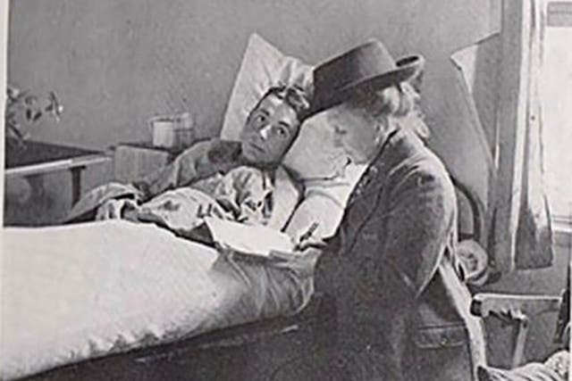 May Bradford writing a letter for an injured soldier in a French hospital