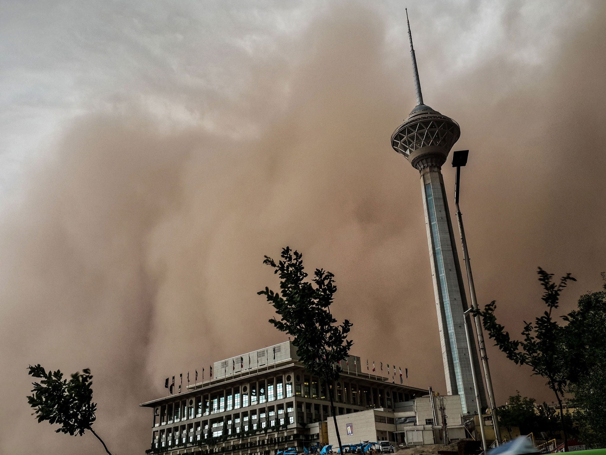 A massive sandstorm and record wind plunged the city into darkness, knocking out power supplies, damaging buildings and causing massive disruption