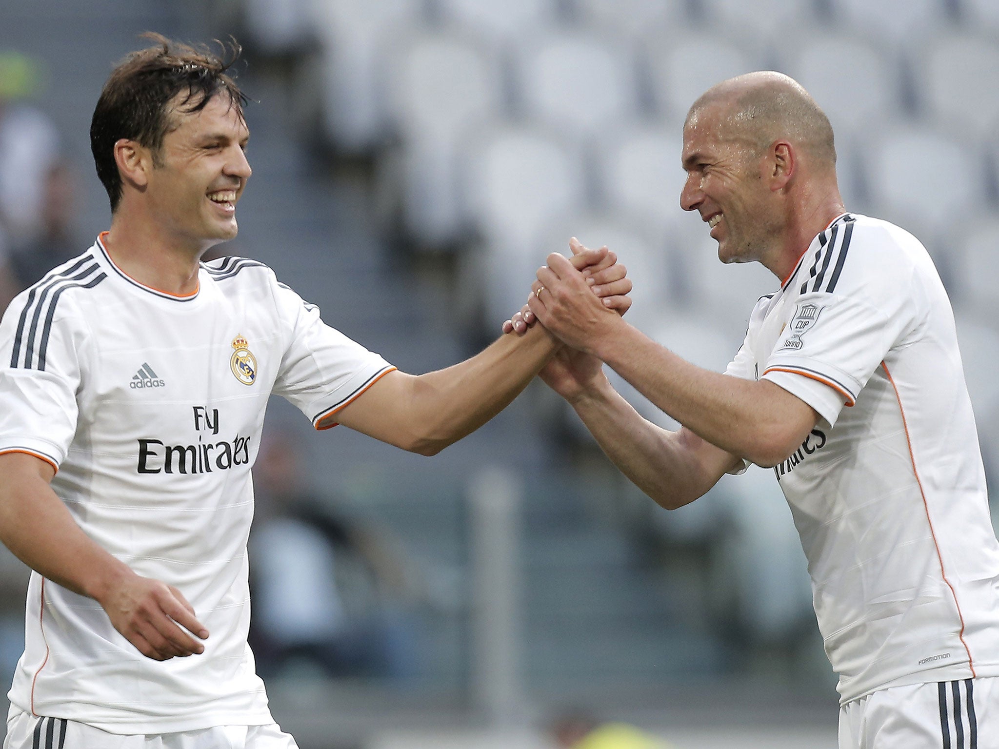 Real Madrid's forward Sanchez Fernando Morientes (L) celebrates with his teammate Zinedine Zidane after scoring during the Unesco Cup football match Juventus Legends vs Real Madrid Leyendas