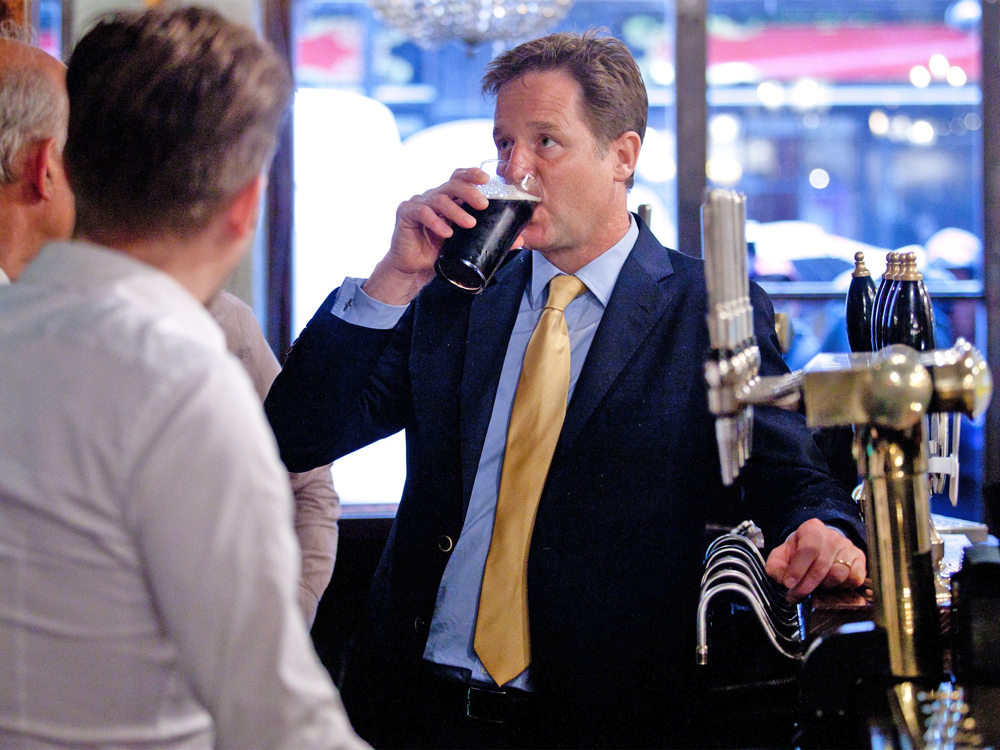 Deputy Prime Minster Nick Clegg sips his pint at the Queens Head Pub in Soho, central London