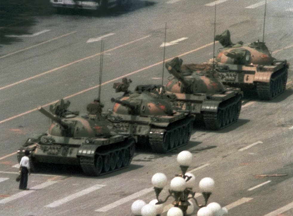 A celebrated image of a man trying to stop the tanks entering the square
