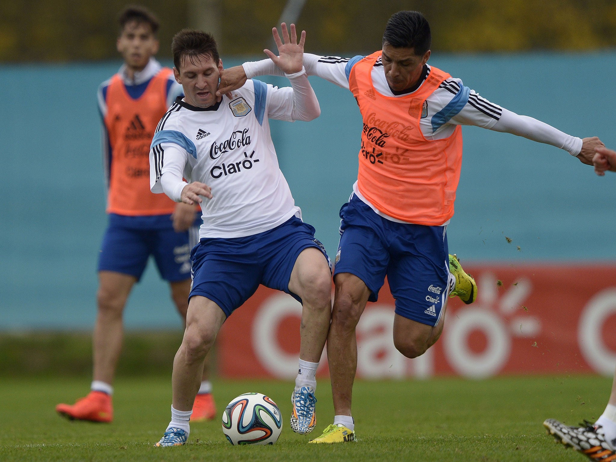 Enzo Perez (right) vies for the ball with Lionel Messi during an Argentina training session