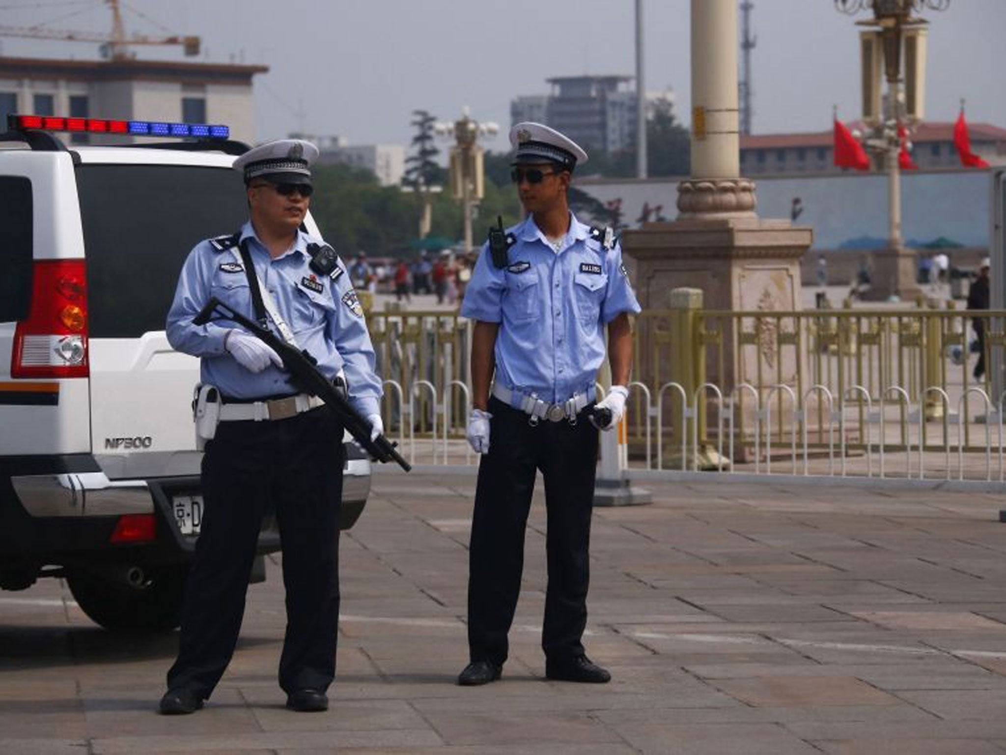 Armed police stand guard at Tiananmen Square in Beijing